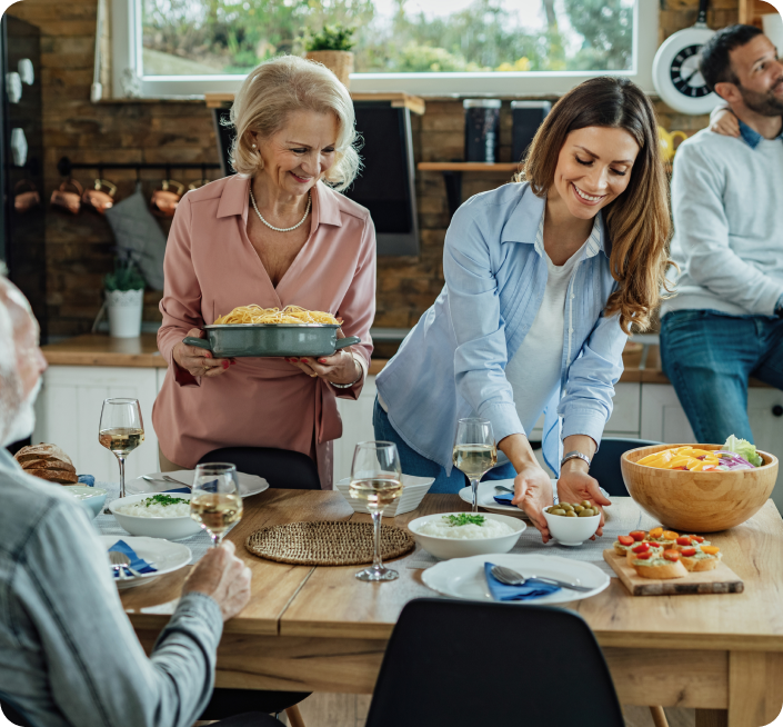 young-woman-her-senior-mother-preparing-dining-table-family-lunch-home (1)